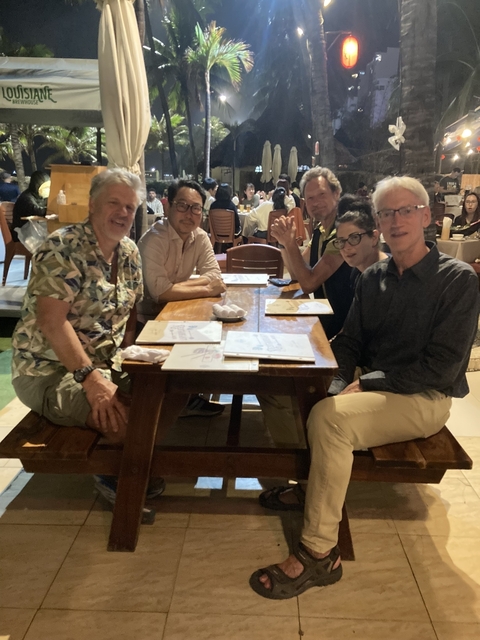 Group of people sitting at a restaurant table.