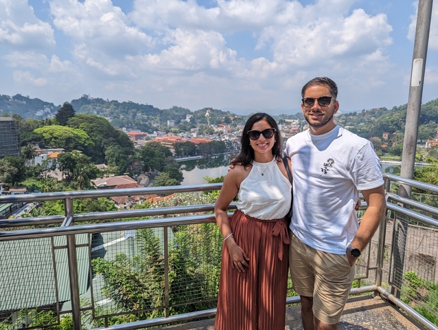       Couple on a lookout with a panoramic view of the city.
  