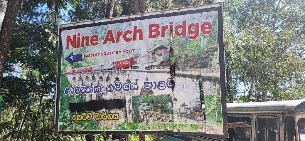       A sign with an image of the Nine Arch Bridge.
  