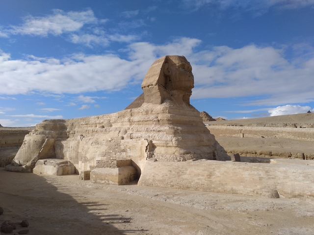 Side view of the Sphinx against a partly cloudy sky.