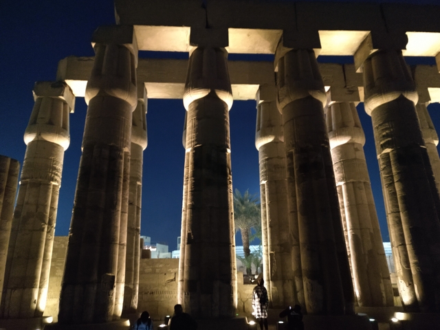 Illuminated ancient columns at night.
