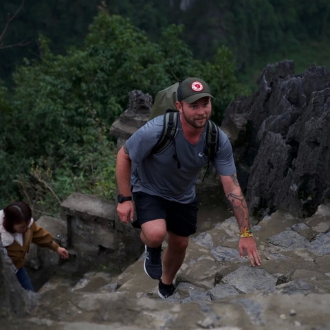      Man hiking up a rocky path.
  