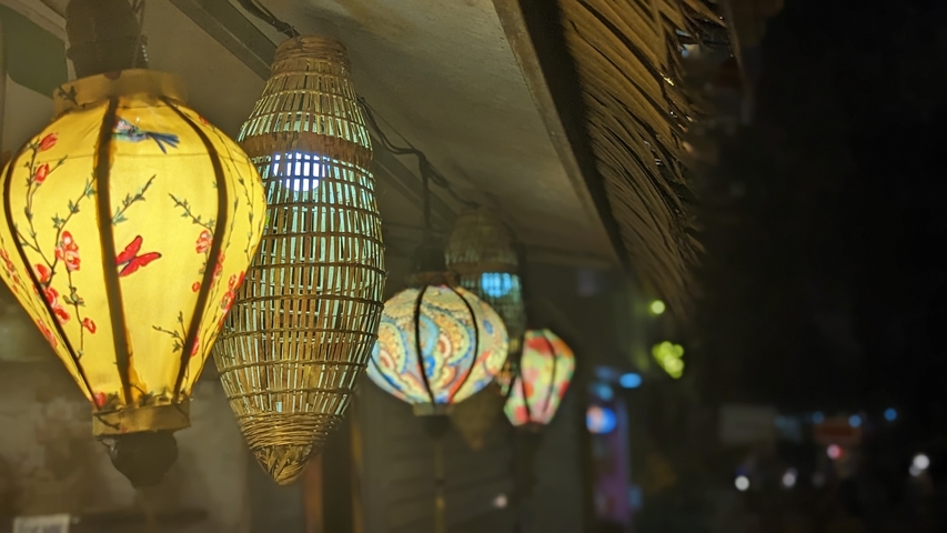       Row of lanterns lit at night creating a warm glow.
  
