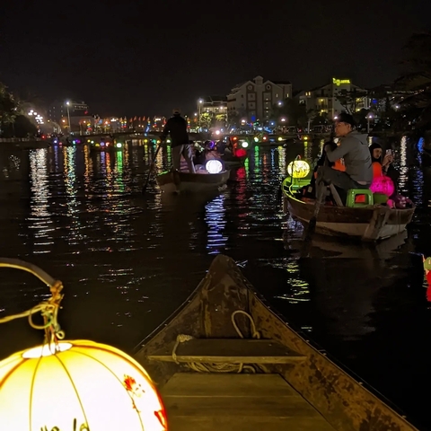       Boat ride during the night with colorful lanterns.
  