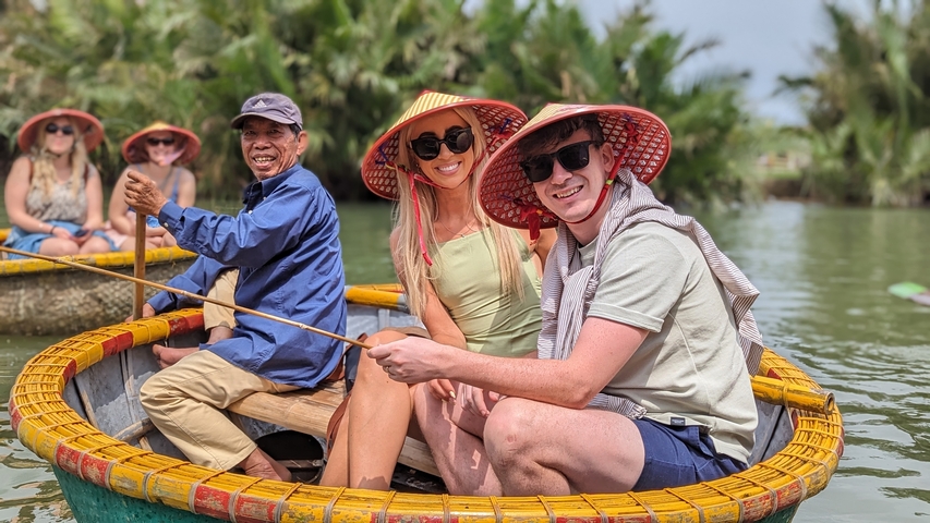       Group of people in traditional basket boats on the river.
  