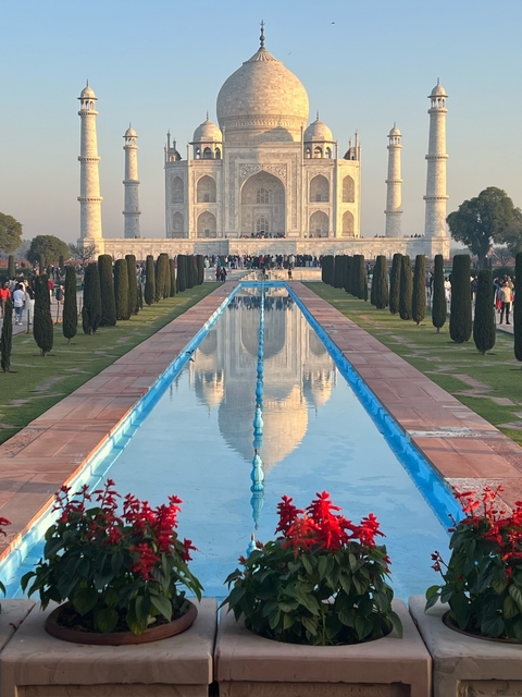      Front view of the Taj Mahal with a reflection in the pool.
  