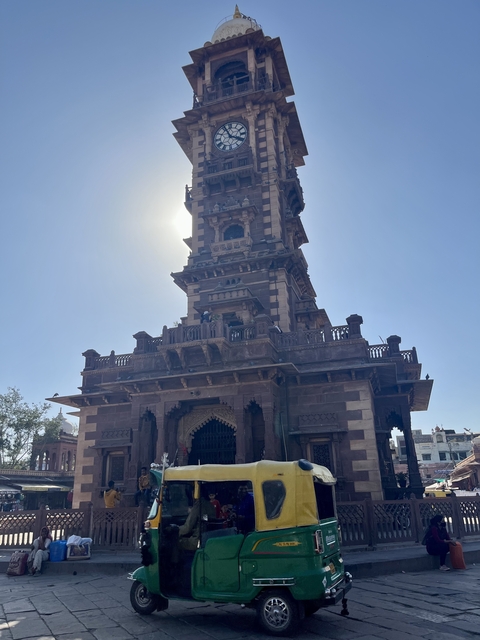 Tower monument with sunlight in the background.