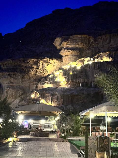 Night scene of a rocky landscape with illuminated areas.