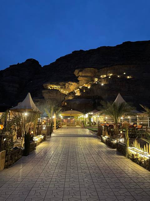       Outdoor venue with lights and seating at night.
  