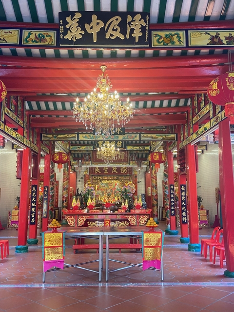       Traditional Chinese temple interior with ornate decorations.
  
