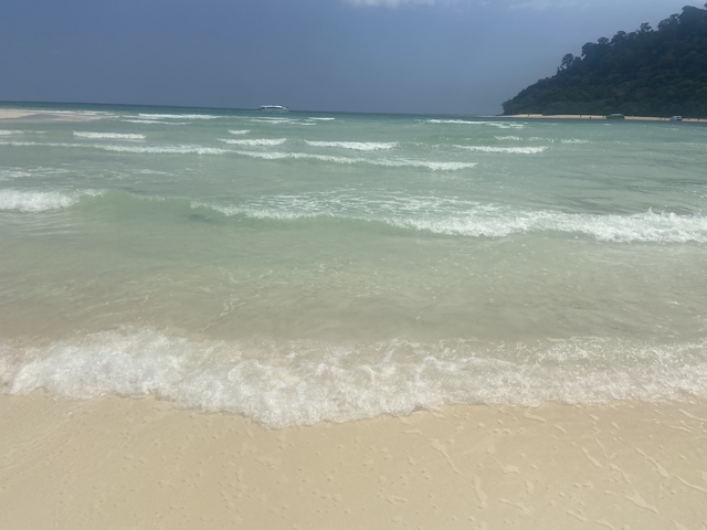       Gentle waves lapping on a sandy beach.
  