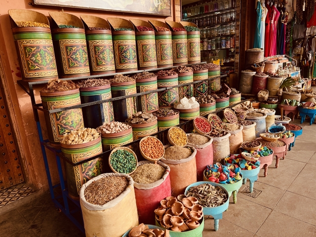 Display of spices and herbs in colorful containers.
