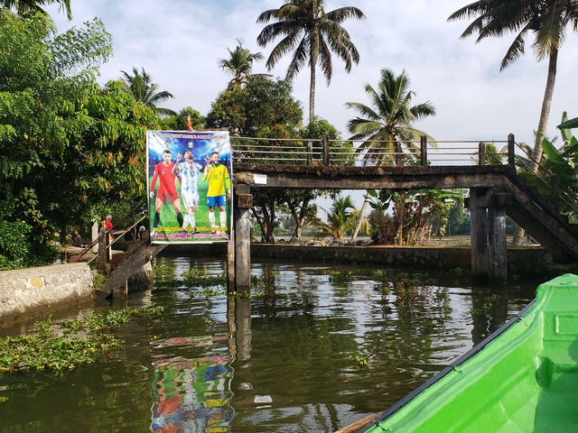 Bridge over a canal with a colorful banner.