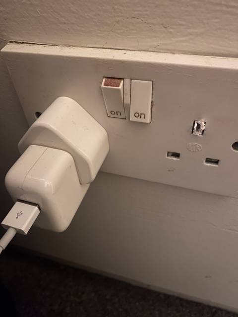 Close-up of a UK-style electrical socket with switches marked on.