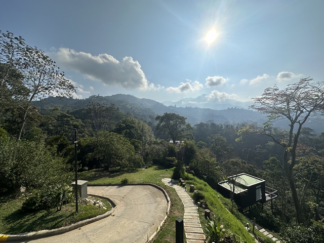 Scenic view of lush mountains and clear sky.