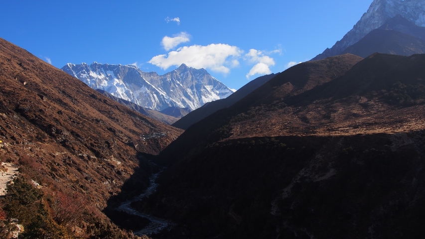       Beautiful mountains with snow-covered peaks and a river in the valley.
  