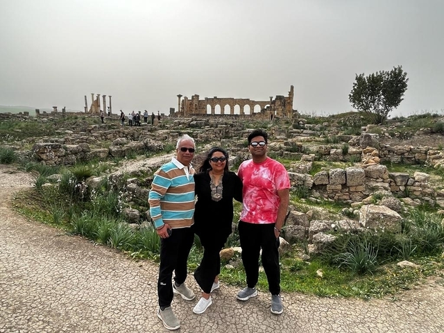       Family posing in an ancient ruin site.
  