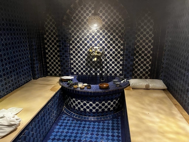 A Moroccan-style bath with blue mosaic tiles.