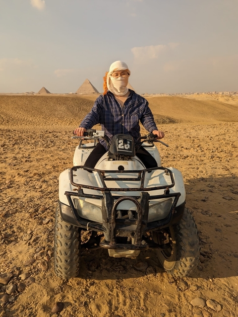 Person riding an ATV in the desert landscape.
