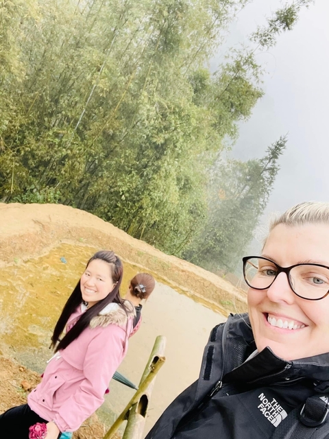 People enjoying a view in a misty natural landscape.