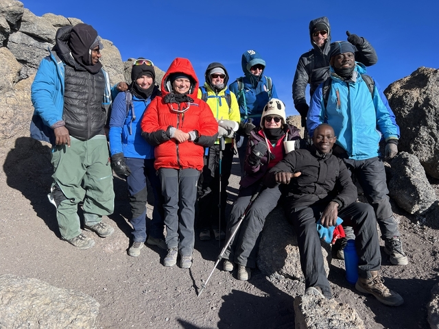 Group of climbers resting on a rocky area.