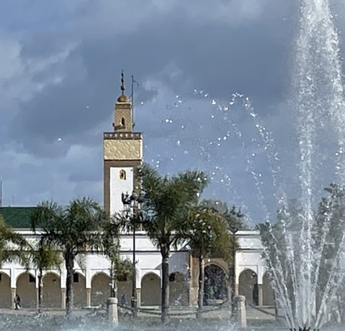 Blurred image of a tower and fountain.