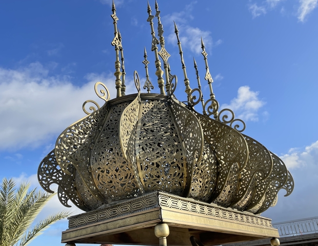 Decorative metal artwork against the sky.
