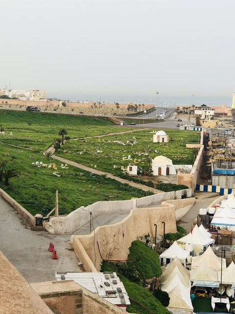Cemetery grounds with a road and distant horizon.
