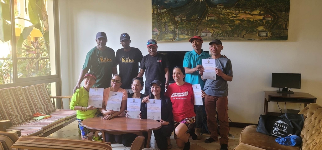       Group of hikers holding certificates.
  