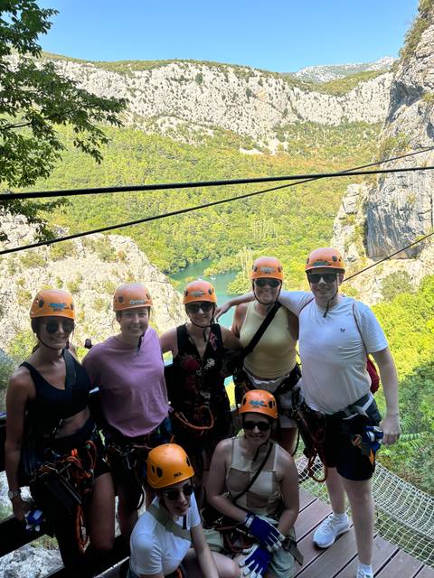 Group of people equipped for an adventure activity with helmets.