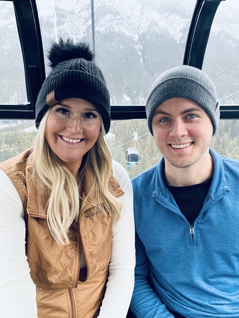       Couple inside a cable car with snowy background.
  