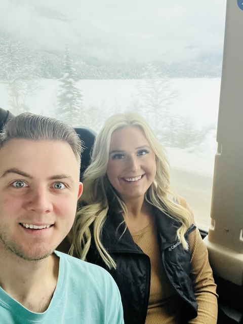       People inside a vehicle in snowy conditions.
  