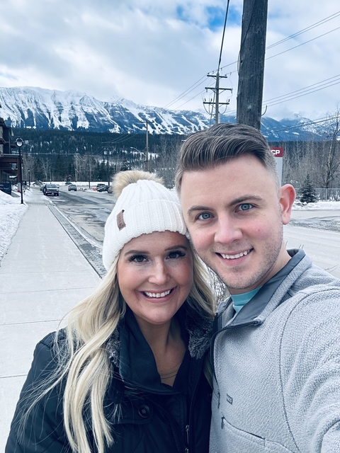       Close-up portrait of a couple on a snowy street.
  