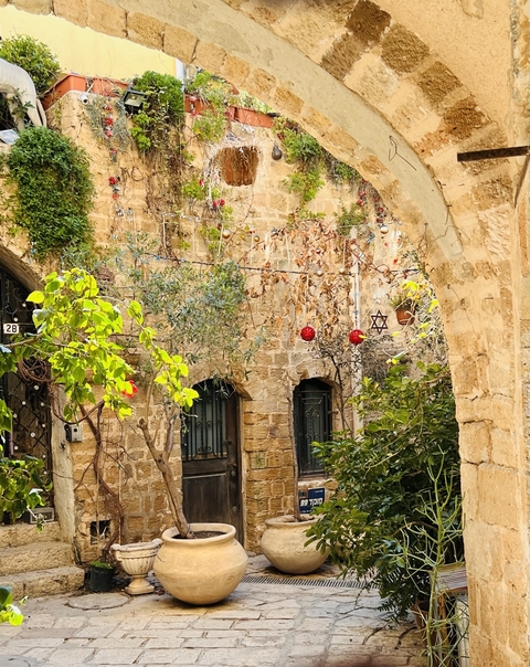 A charming courtyard with decorations and stone arches.