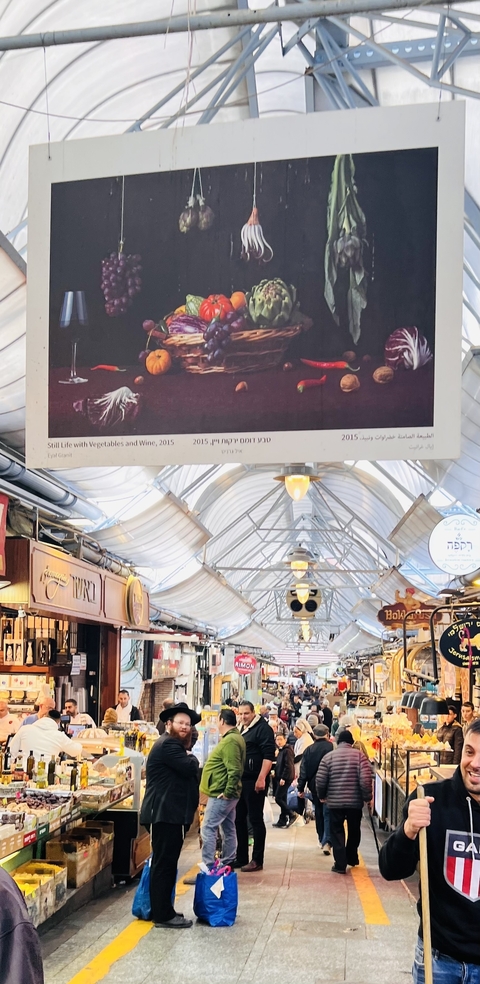 Indoor market with hanging decorations and signage.