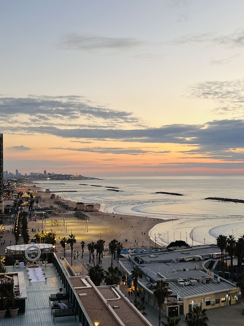 Beautiful seaside at sunset with city skyline.