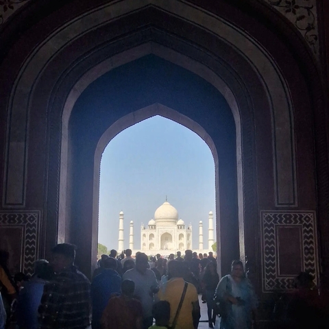 The Taj Mahal viewed through an arched doorway.