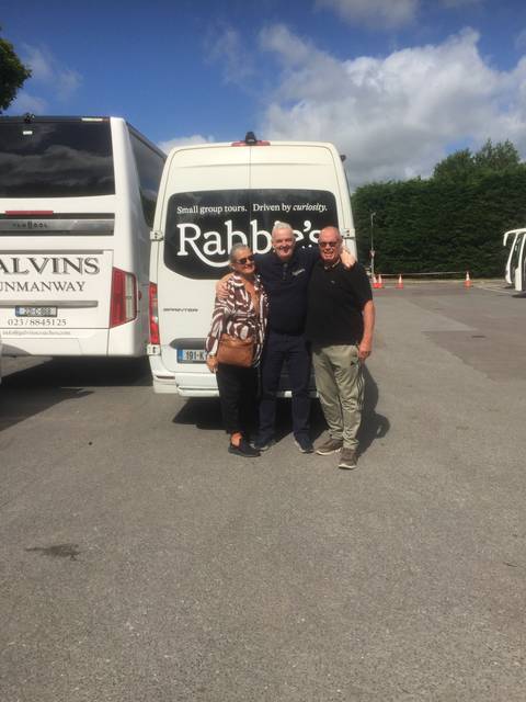       Group of people posing in front of a van.
  