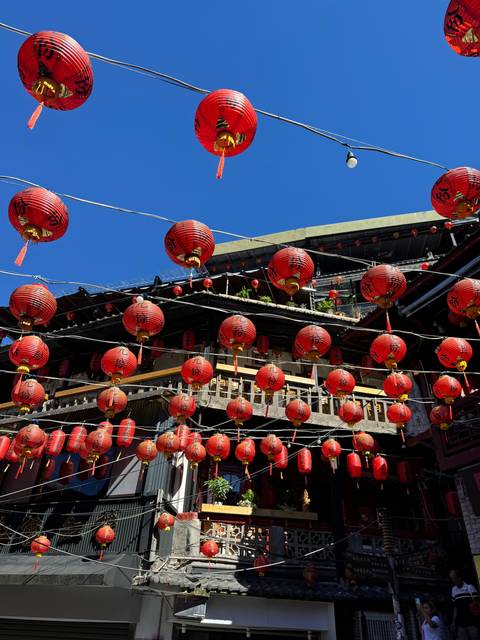 Bright red lanterns hanging between buildings.