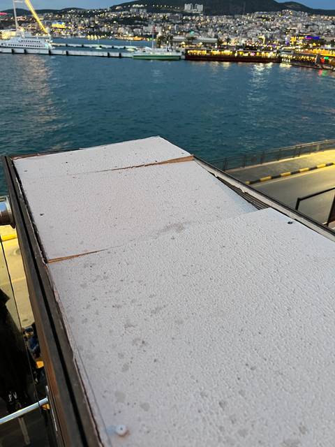       View of a body of water with buildings in the background.
  