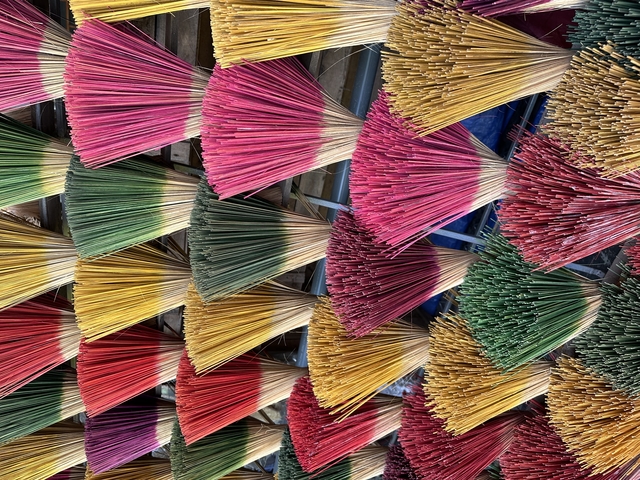 Colorful arrays of incense sticks arranged in bundles.