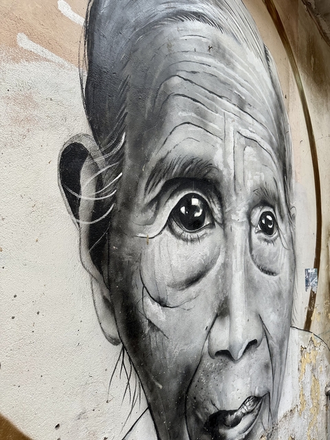 Graffiti artwork depicting a face on a wall.
