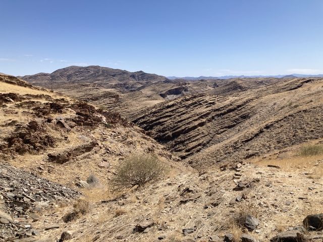       Mountainous desert terrain under a clear sky.
  