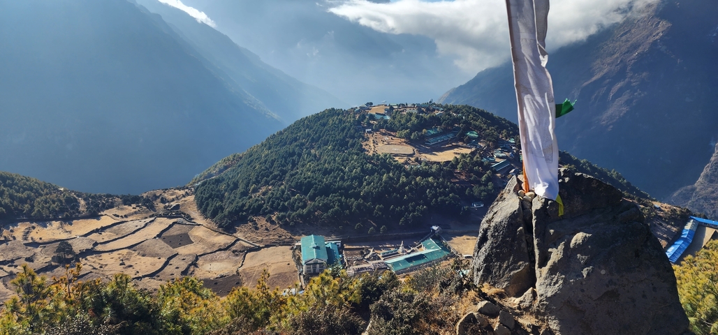       Aerial view of a village nestled in a mountainous landscape.
  