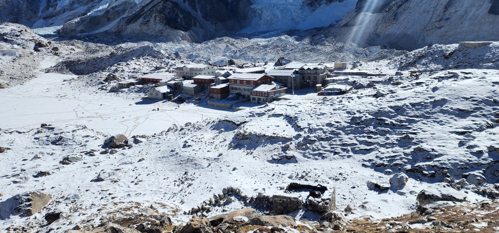       Snow-covered settlement nestled in a rugged mountain area.
  