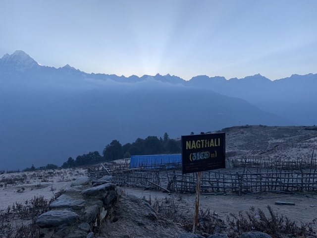 Distant mountain range with a sign indicating altitude.