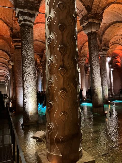       Interior of a historic building with columns and lights.
  