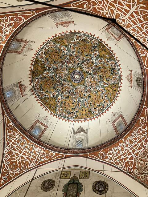       Intricately designed mosaic ceiling with vibrant colors and patterns.
  