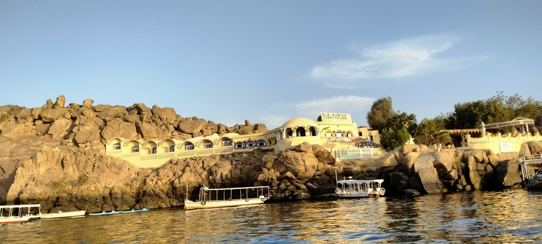 A scenic view of buildings on a rocky riverside.