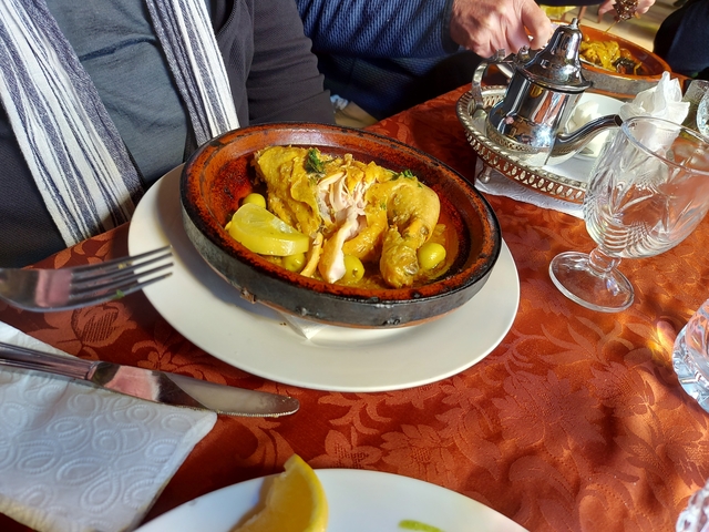 Tagine dish with vegetables and lemon on a plate.